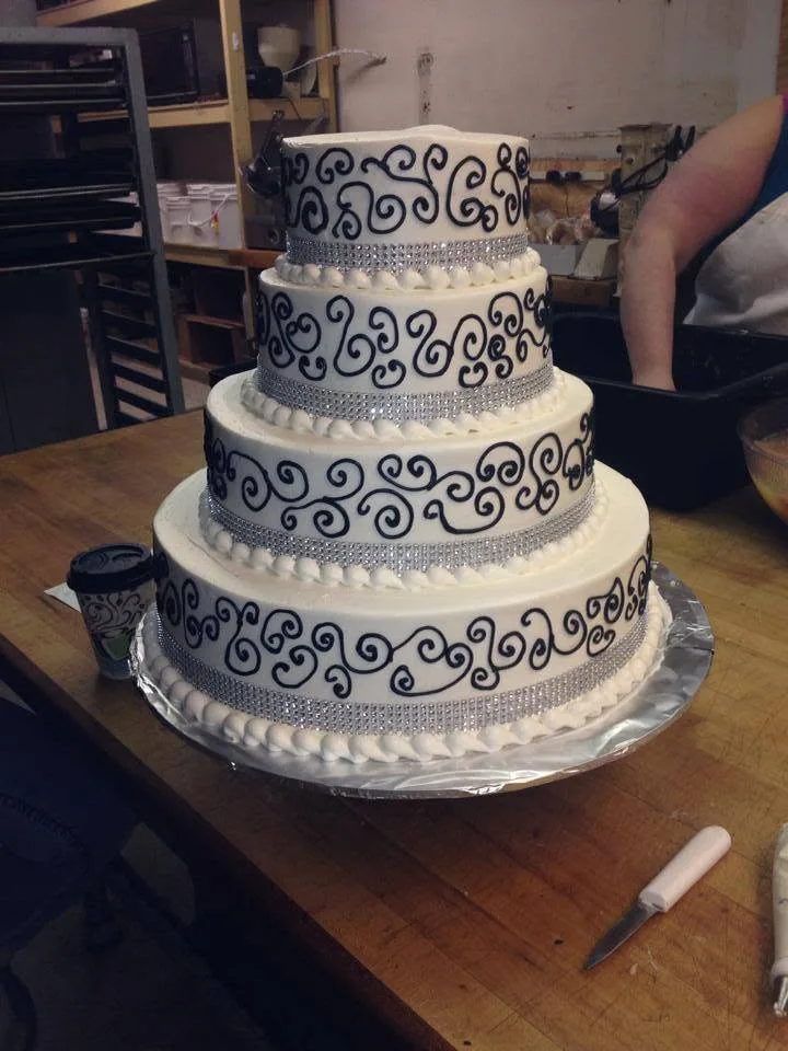 Tiered wedding cake with scrollwork